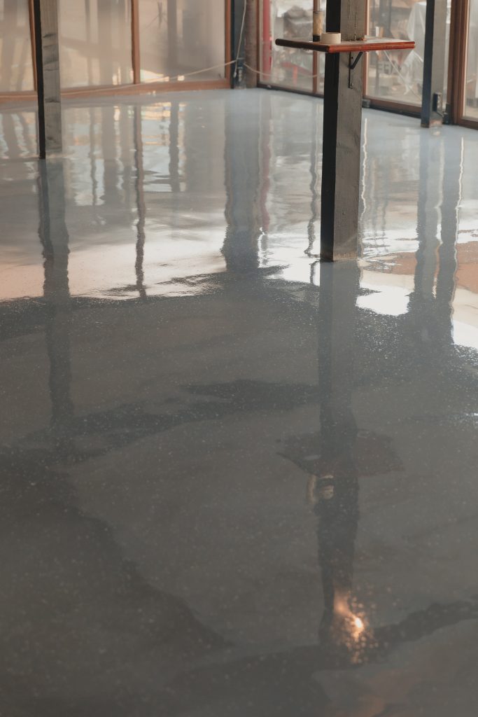 The empty space features a light gray floor with a reflective surface.